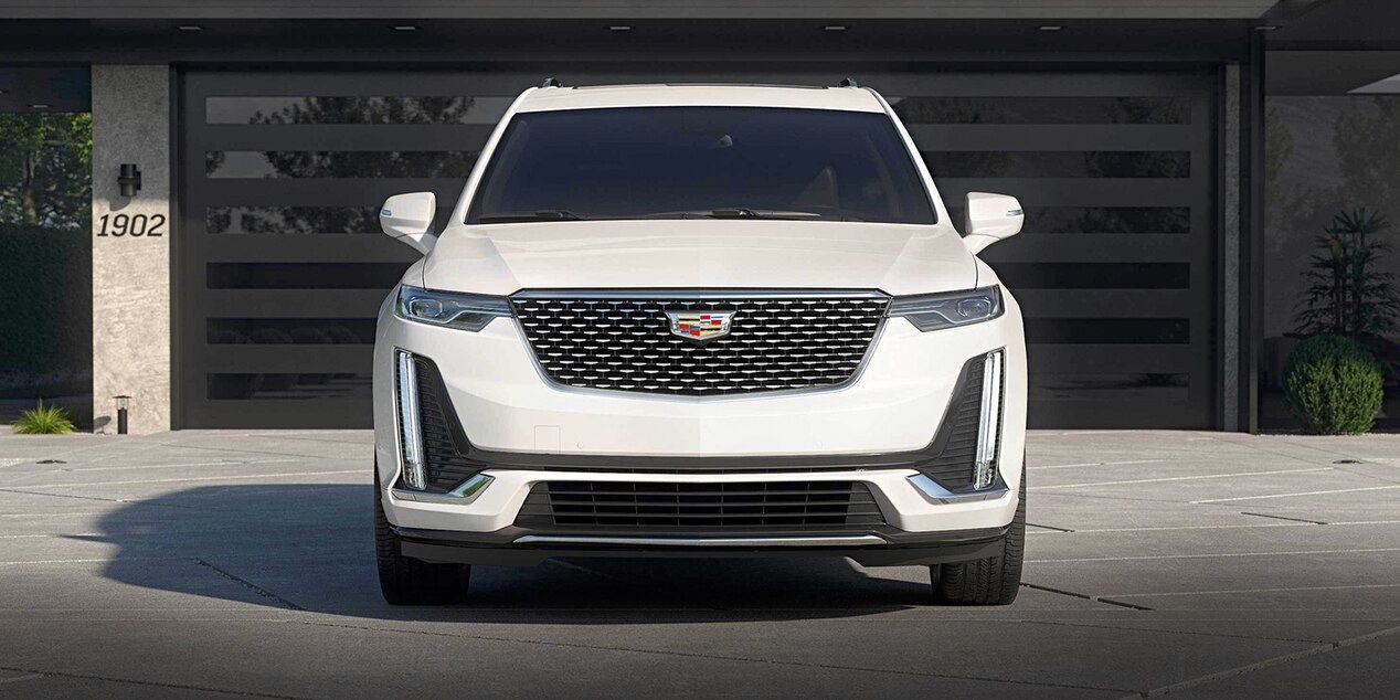 Front view of the Cadillac XT6 parked in front of a residential garage.