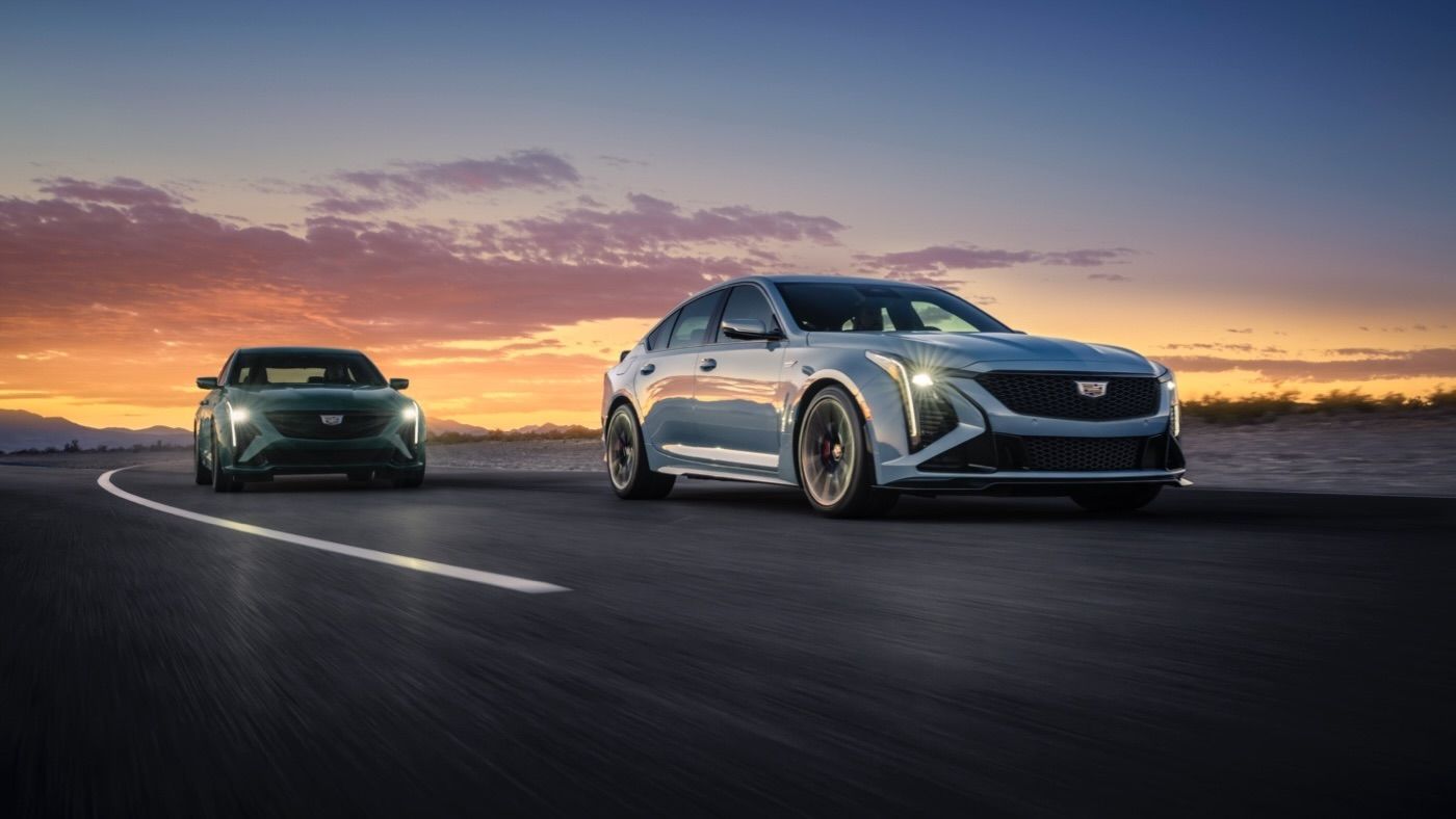 Two Cadillac CT5-V driving on a closed circuit at sunset