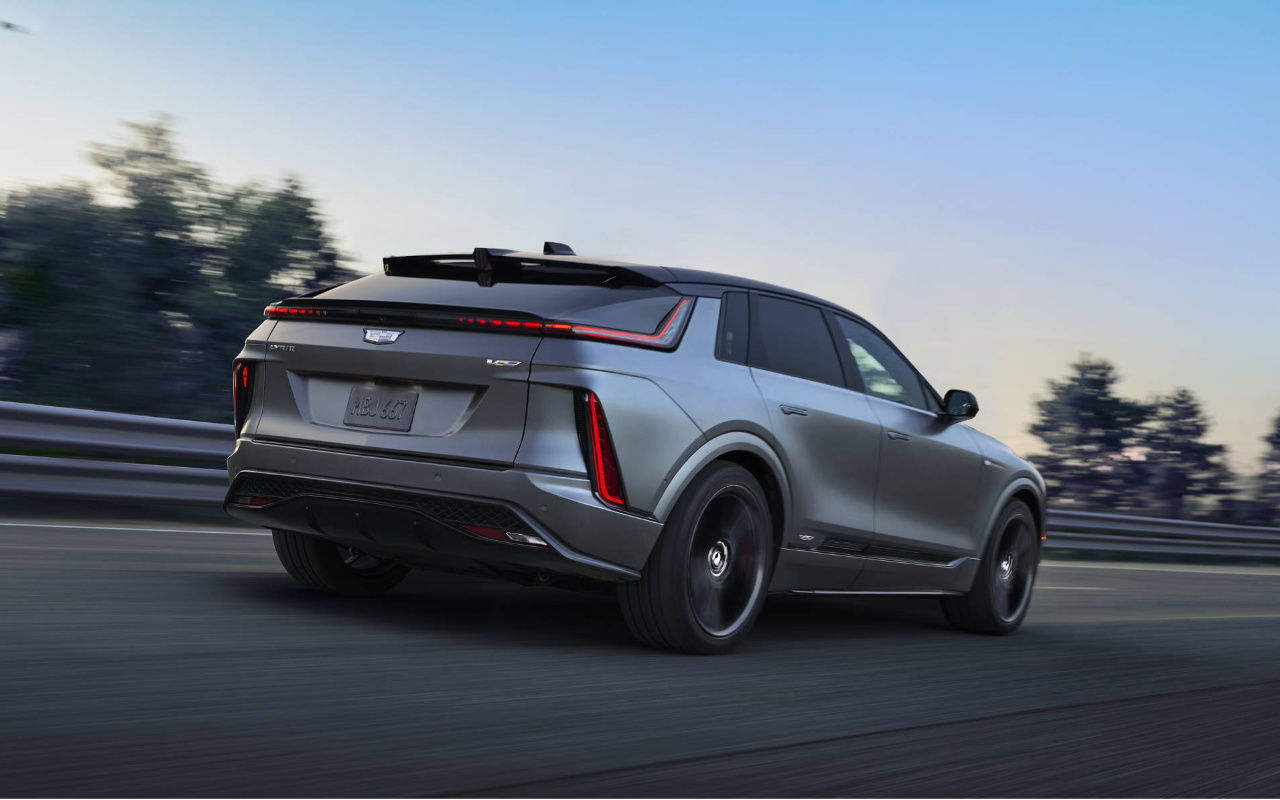 rear side view of a 2026 Cadillac Lyriq-V on the road at dusk