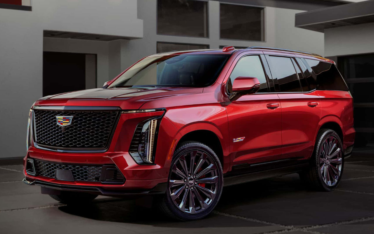 front side view of a 2025 Cadillac Escalade V in front of a modern building