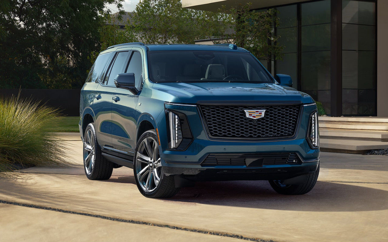 front side view of a 2025 Cadillac Escalade parked in front of a modern house