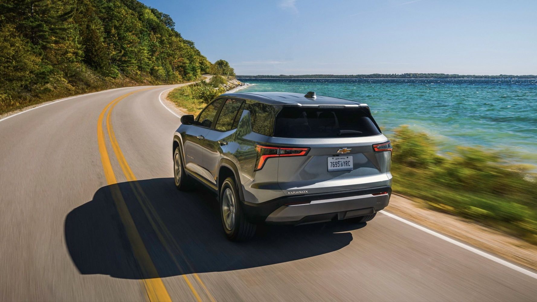 The Chevrolet Equinox 2025 on a waterfront road.