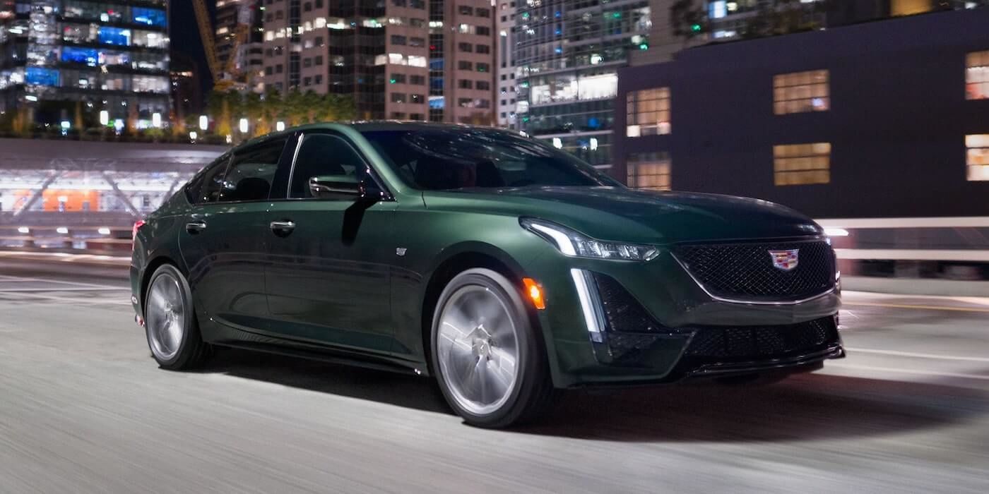 The green 2021 Cadillac CT5 Premium Luxury on the city road