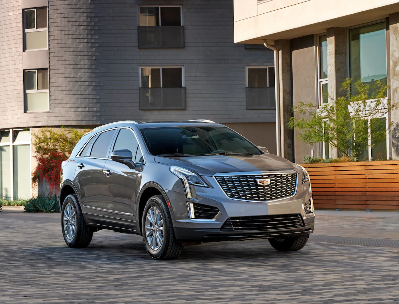 The gray color 2021 Cadillac XT5 SUV parked on a paving stone