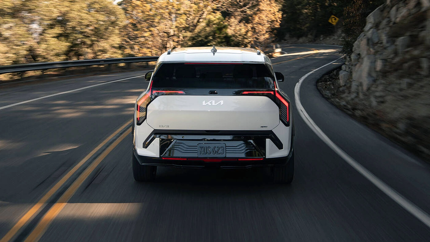 Rear view of the Kia EV3 on the road