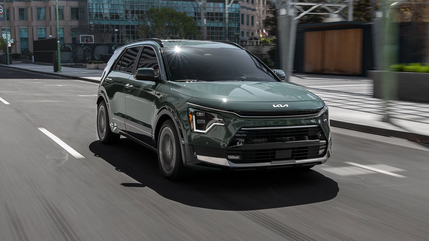Three-quarter front and side view of the 2026 Kia Niro EV on the road at full power