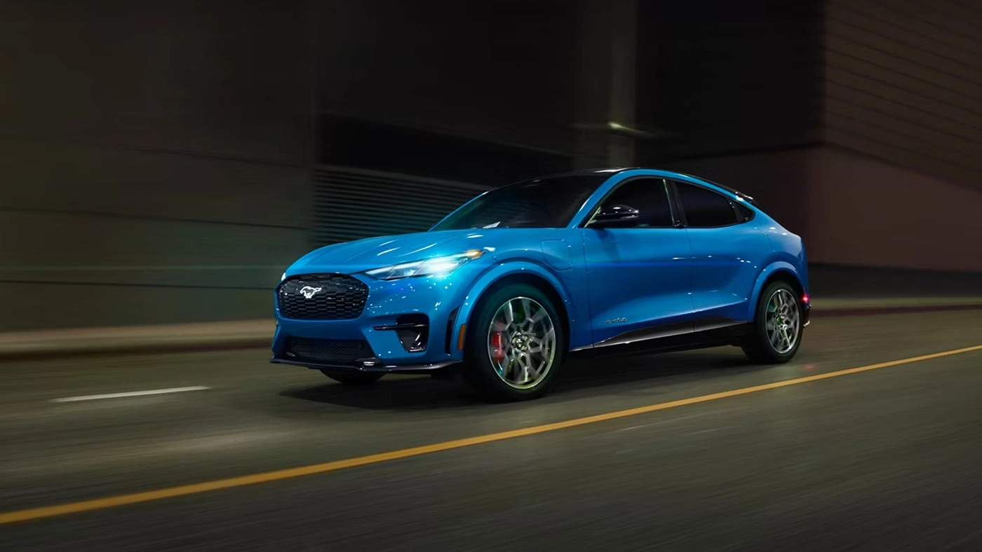 Three-quarter front and side view of the 2026 Ford Mustang Mach-E on the road at full throttle