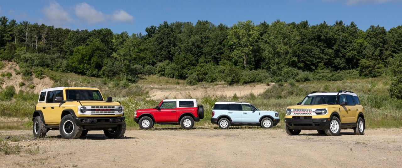 La gamme de 4 VUS Ford Bronco, versions Sport et Heritage garés à l'extérieur.