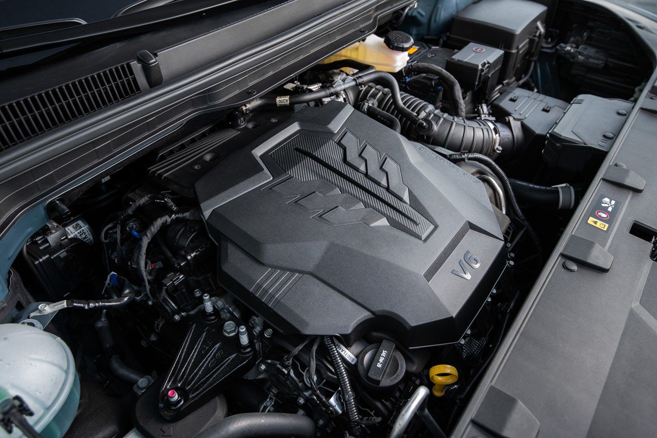 close up view of the engine of a 2024 Kia Carnival