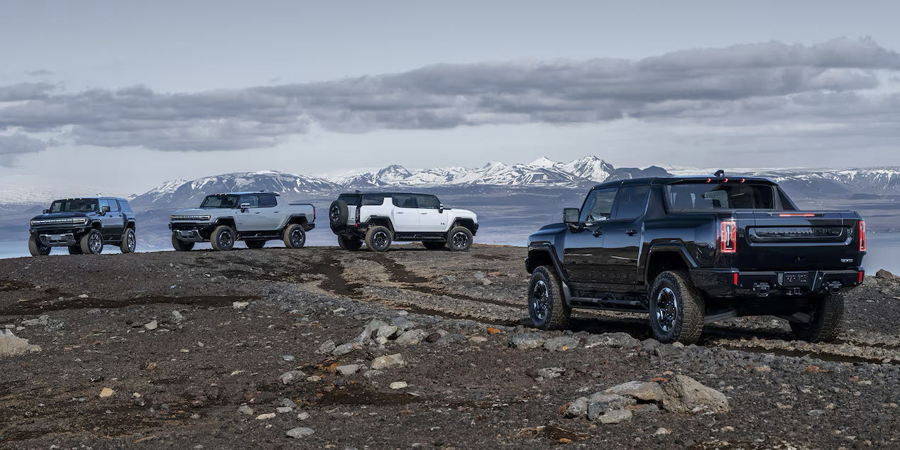 Image of Hummer EV 2025 trucks and SUVs at the top of a mountain.