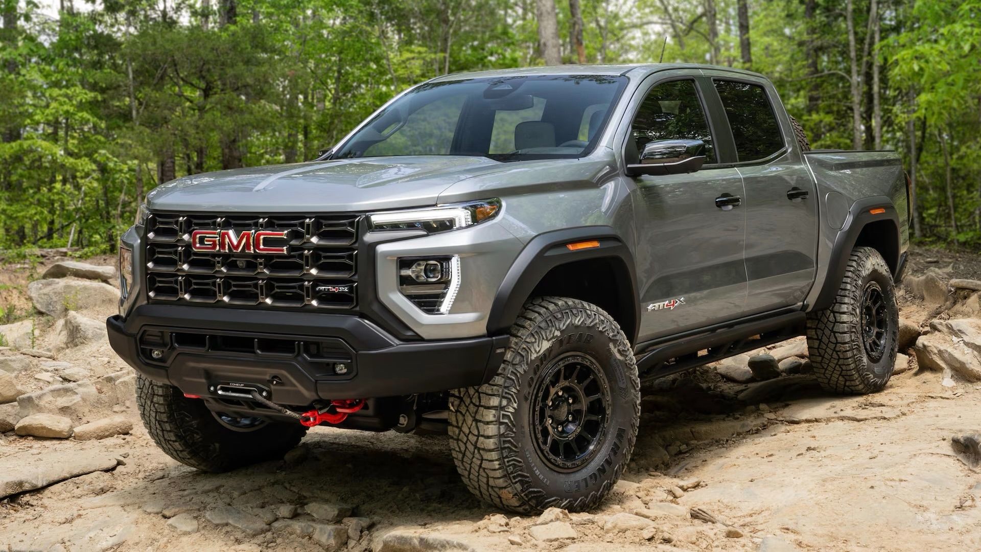 The GMC Canyon rolling over rocks.