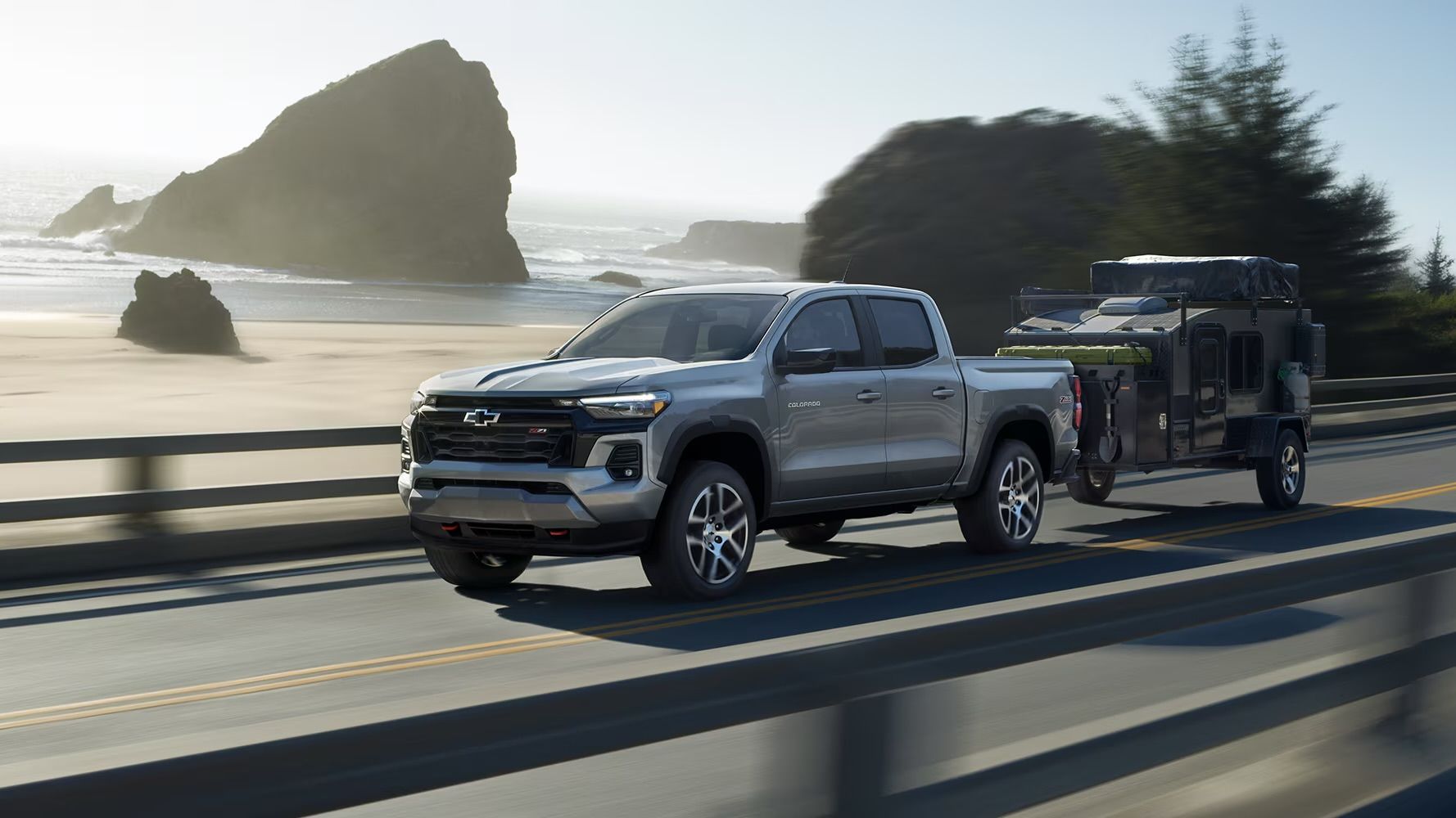 The Chevrolet Colorado towing a mini-trailer.