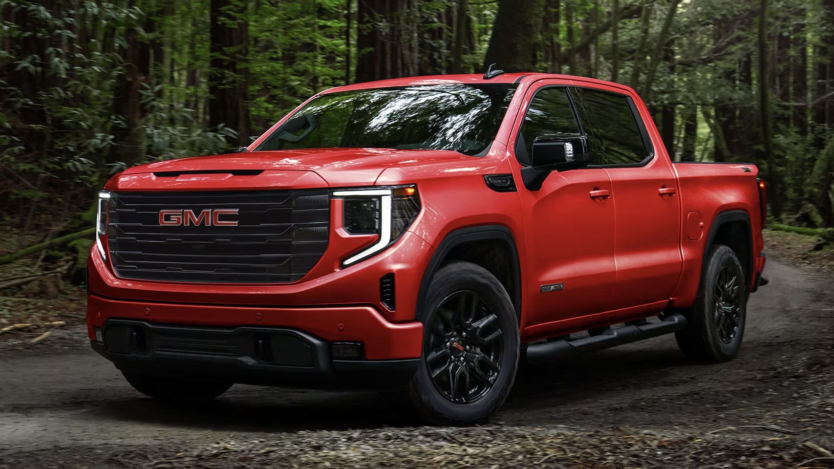 The Gmc Sierra 1500 driving through the forest.