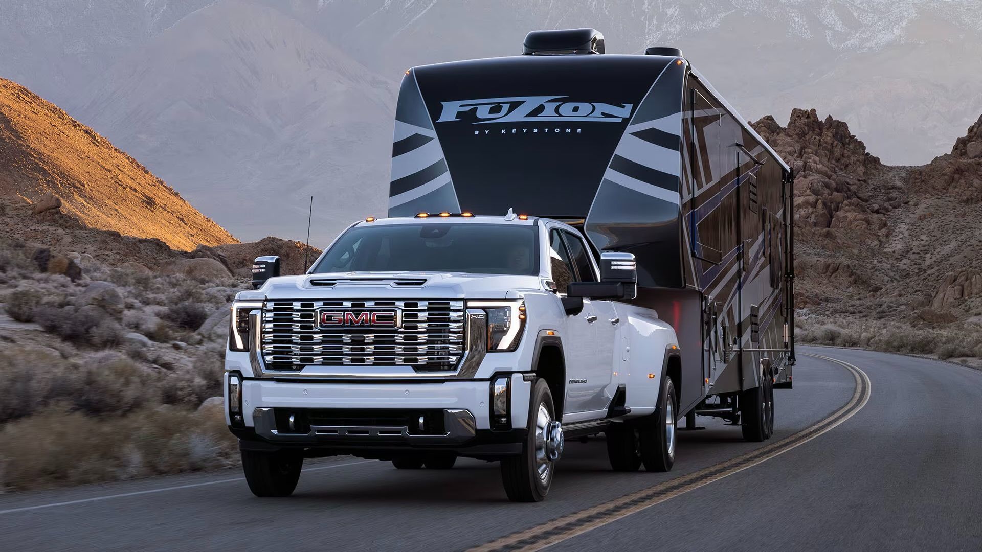 The GMC Sierra 2025 towing a large trailer.