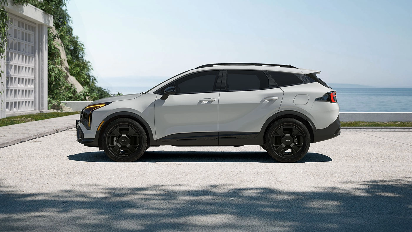 Side view of the 2026 Kia Sportage parked by the sea