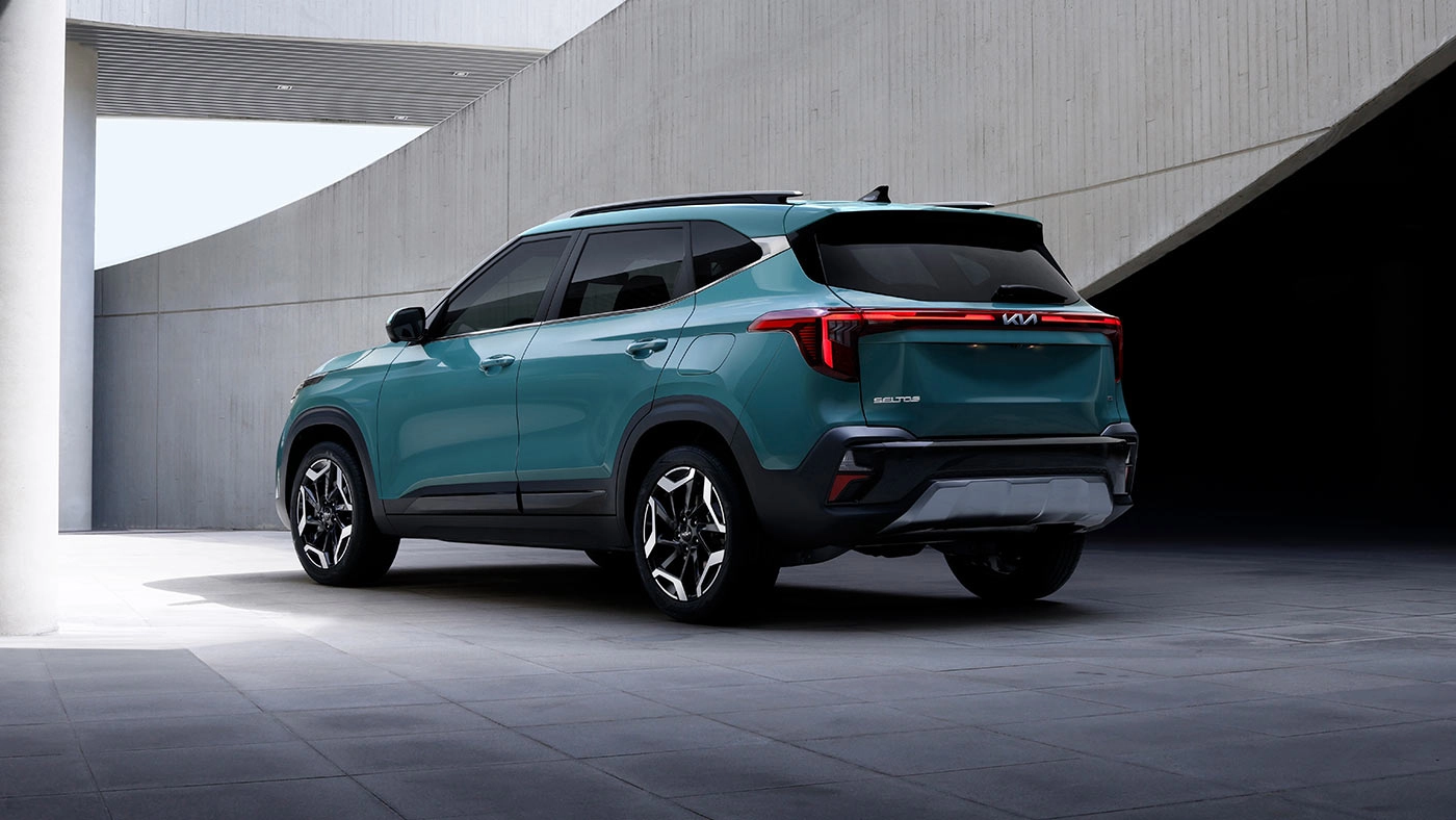 Rear view of the 2026 Kia Seltos parked in front of a luxurious public building
