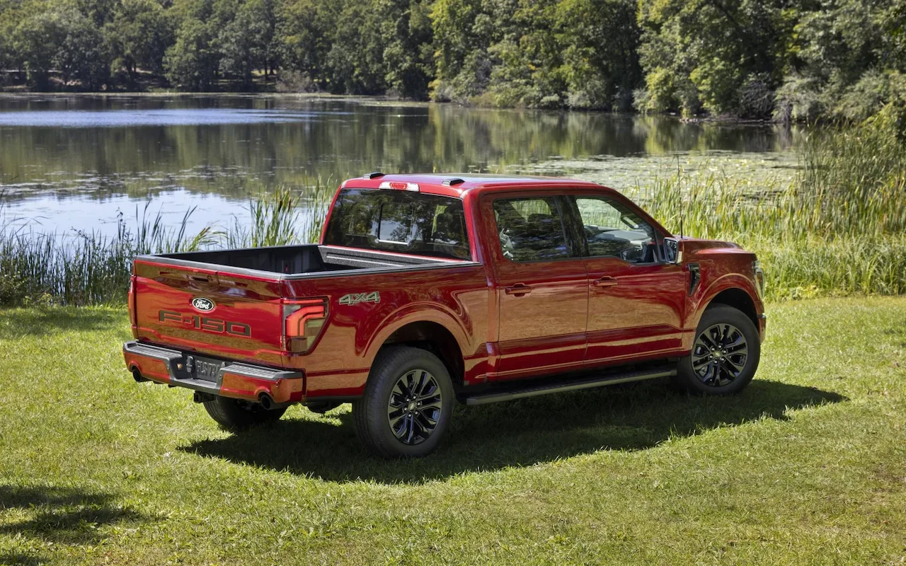 Rear view of a red Ford F-150 near a lake.