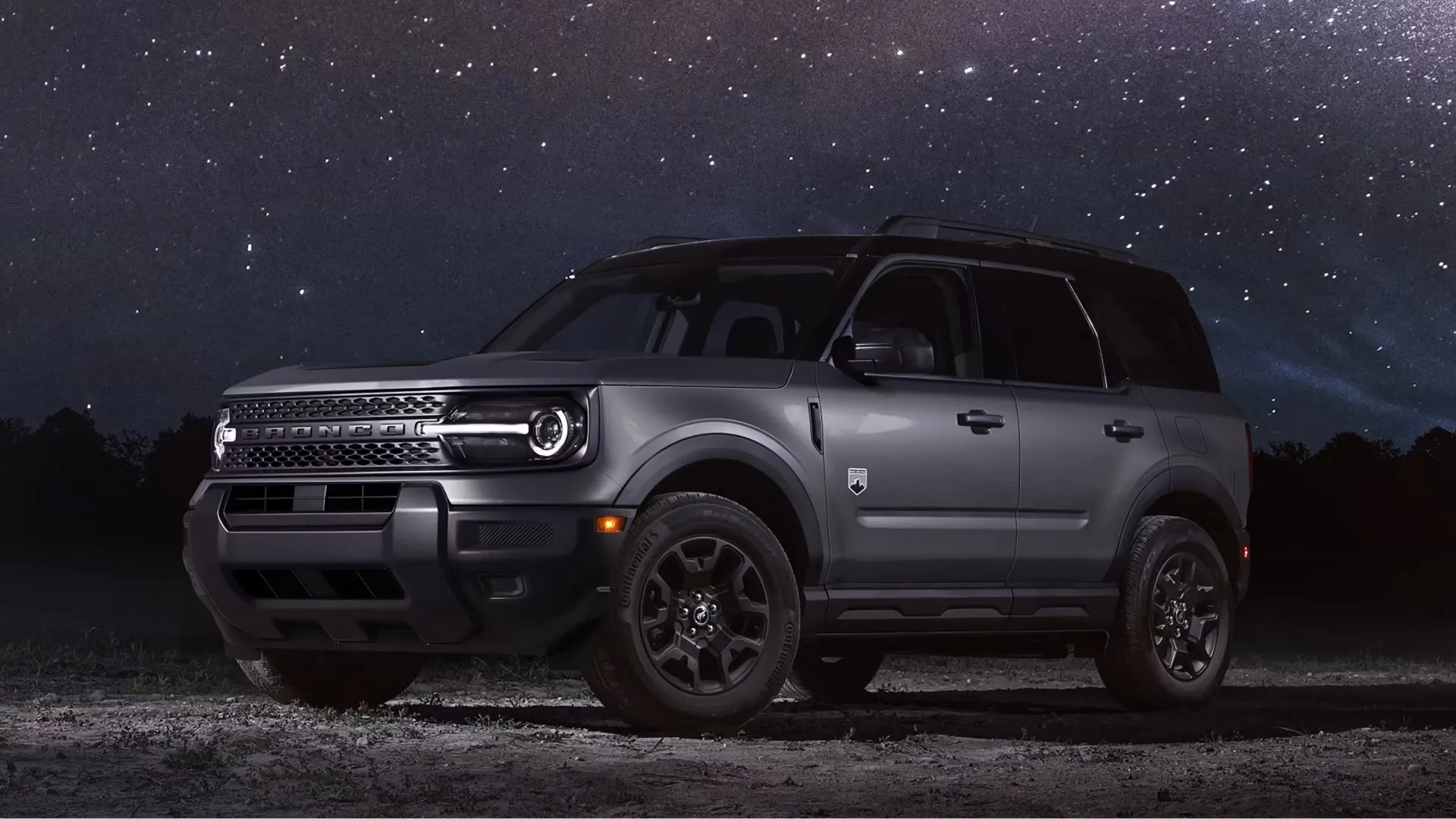 Grey Ford Bronco Sport under a starry sky.