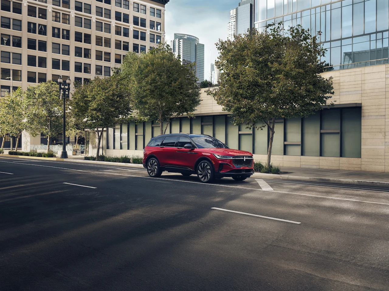 Red Lincoln Nautilus driving through an urban environment.