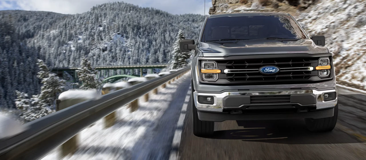 2026 Ford F-150 driving on a snowy road.