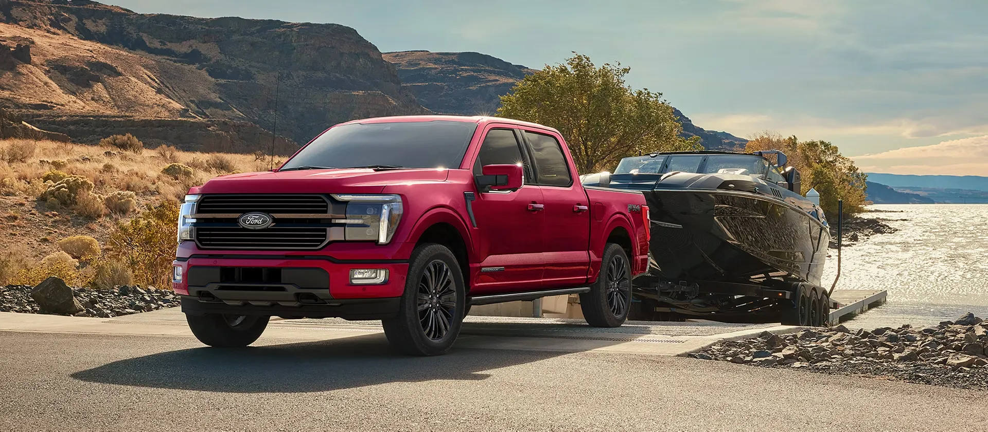 Red 2026 Ford F-150 towing a boat.