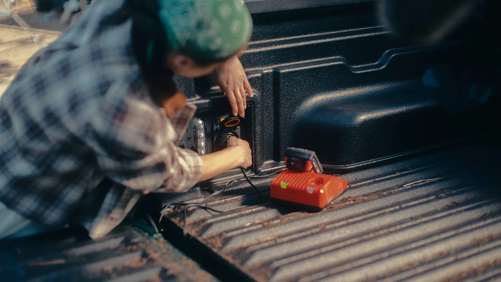 DIYer using an electrical outlet in the bed of the 2026 Ford Maverick.