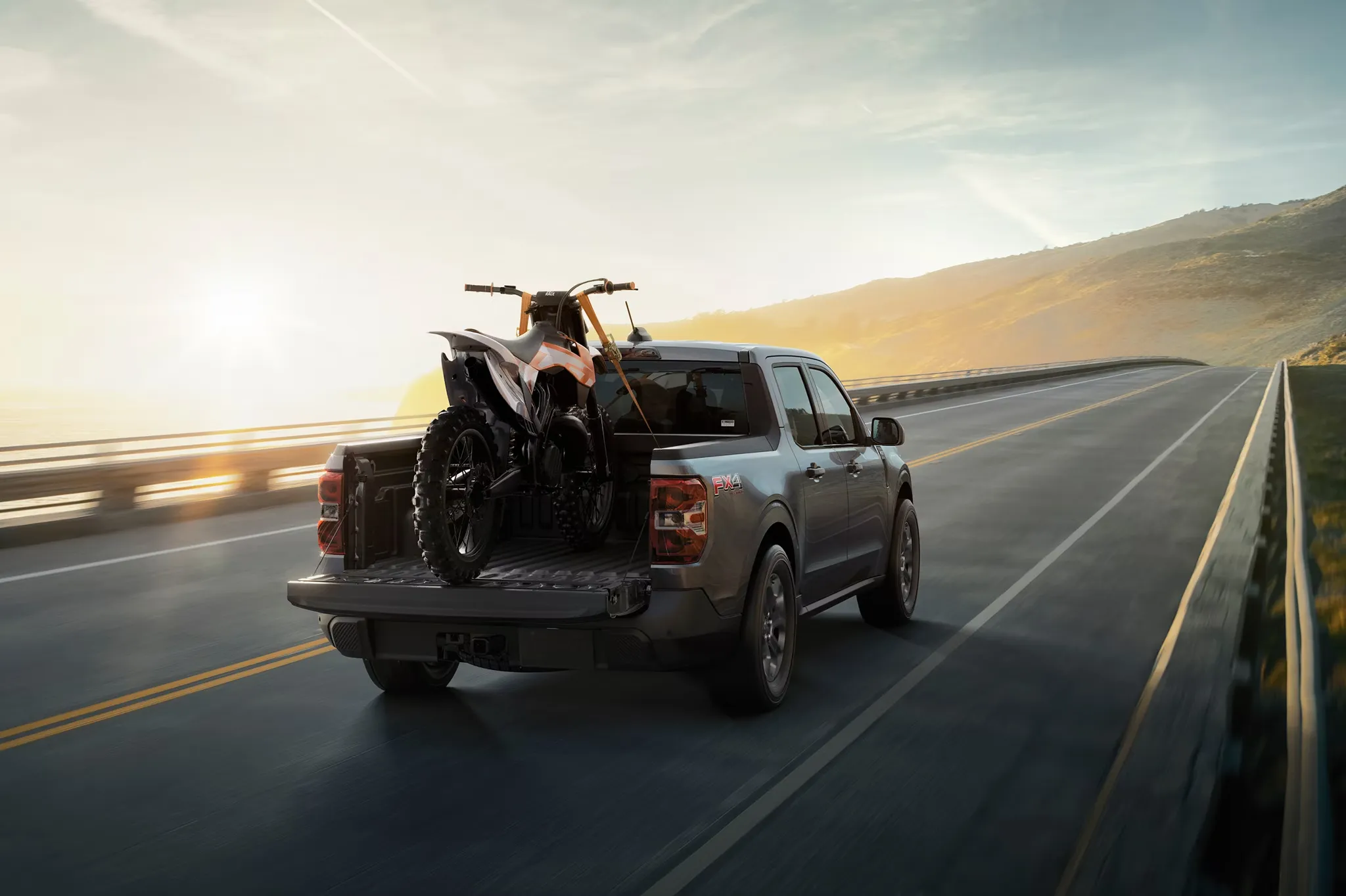 2026 Ford Maverick carrying an all-terrain vehicle in its bed.