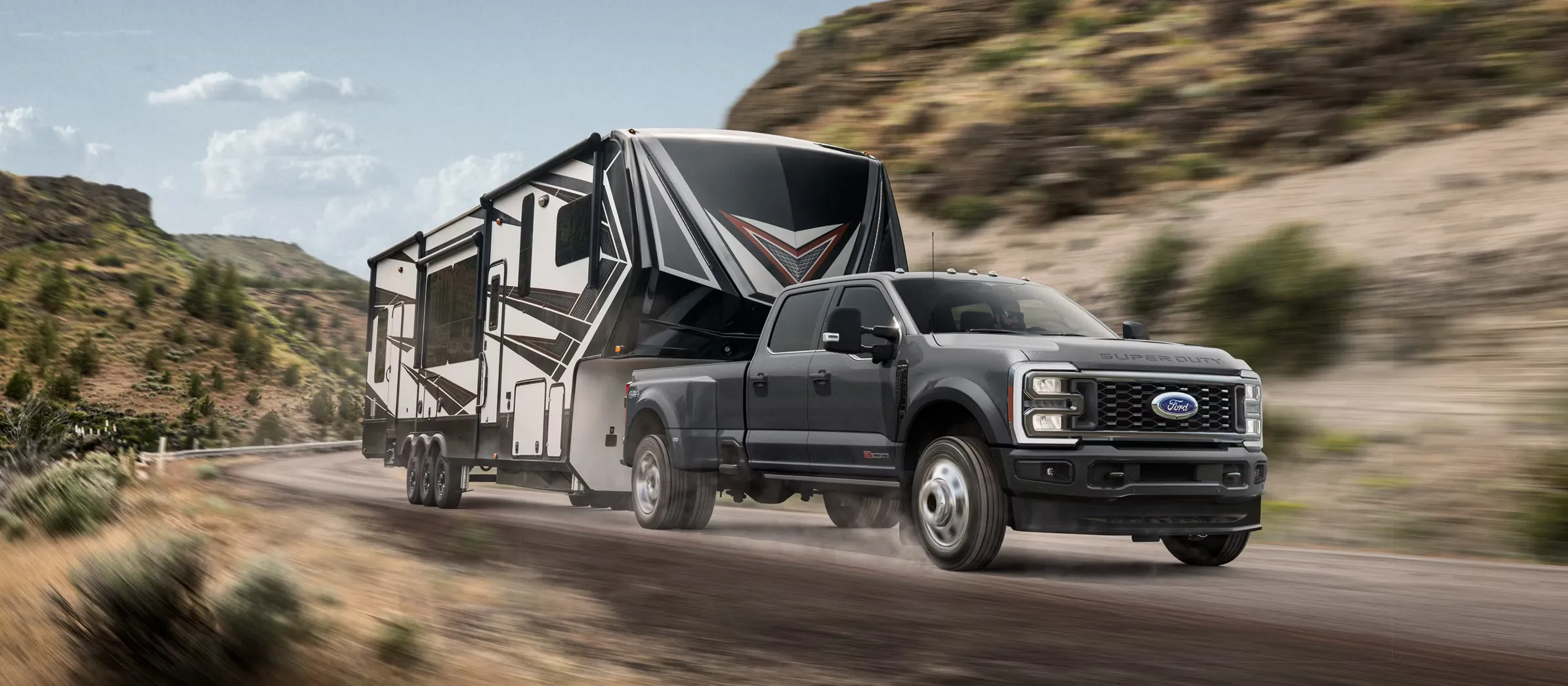 2026 Ford F-450 Super Duty towing a large fifth-wheel trailer.