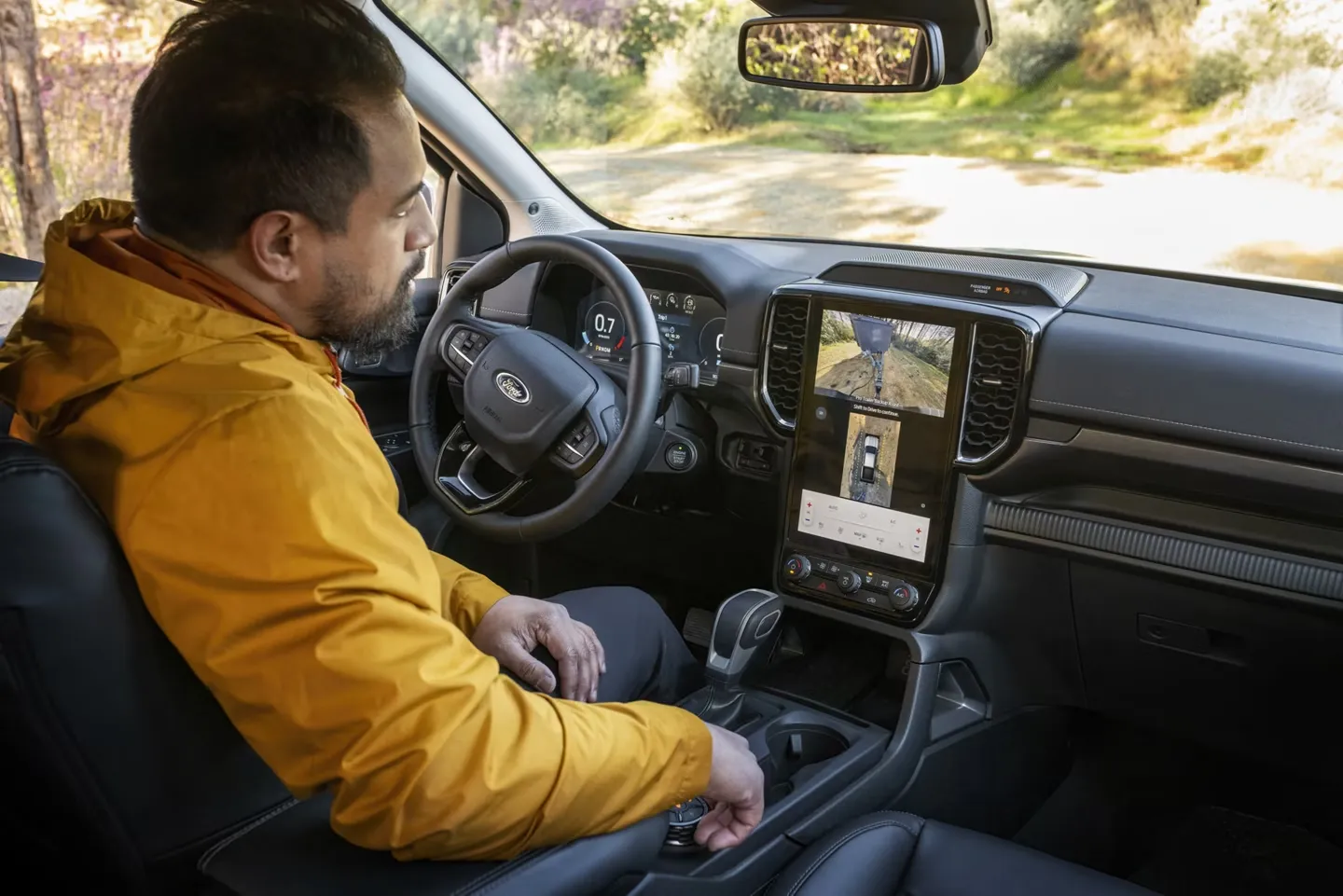Driver using 2026 Ford Ranger towing-assistance technologies.