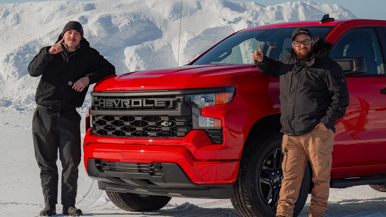 Chevrolet Silverado 2026 rouge et ses deux fans qui posent fi&egrave;rement dans le froid