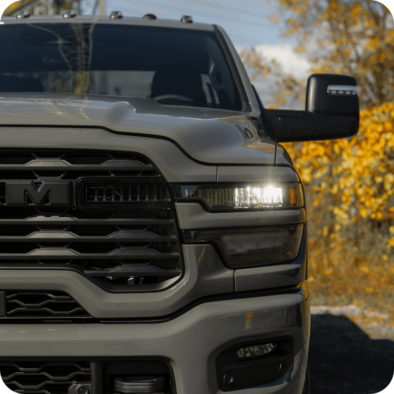 Headlight of a gray Heavy Duty Ram.