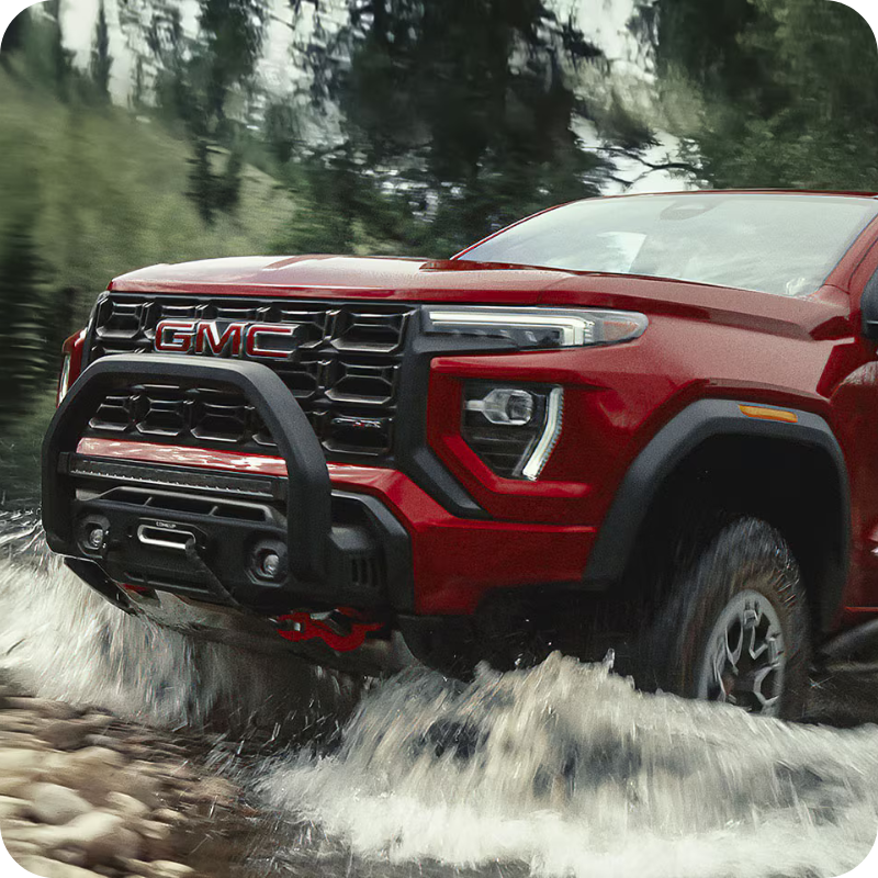 Front view of the 2026 GMC Canyon driving through a puddle