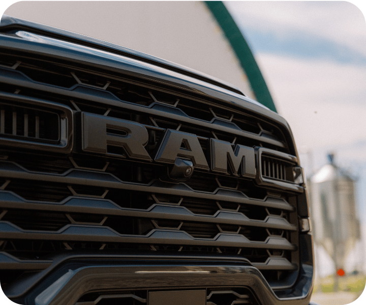 Close-up view of the front of the 2026 RAM 2500 on a farm