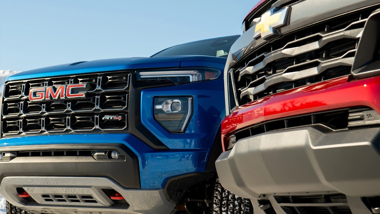 Head-to-head comparison of the 2026 GMC Sierra AT4 and the 2026 Chevrolet Silverado — two rival full-size trucks under the same brand.