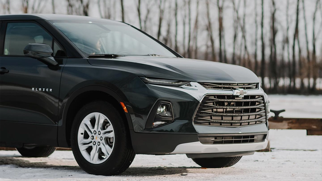 A 2026 Chevrolet Blazer against a winter backdrop; its sporty design and chrome grille perfectly capture the modern style of midsize SUVs.
