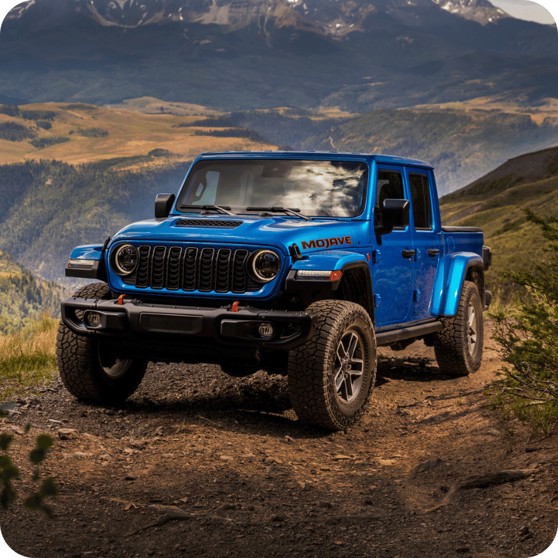 Blue Jeep Gladiator Mojave in mountains.