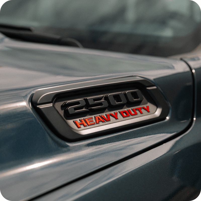 Close-up of the "2500 Heavy Duty" badge on the hood of a gray Ram pickup truck.