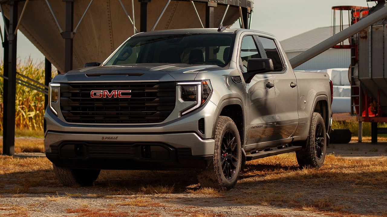 Three-quarter front and side view of the 2026 Sierra 1500, parked at a farm