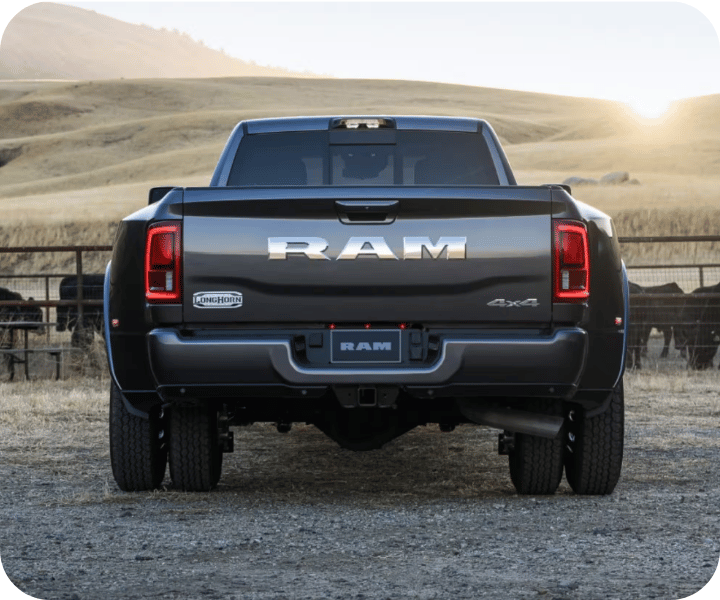 Rear view of the 2026 RAM 3500 parked on the edge of a ranch