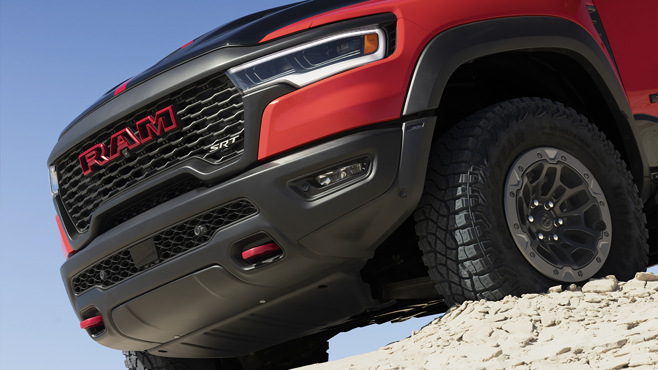 Close-up view of the front of a 2027 Ram 1500 TRX SRT on a sand dune