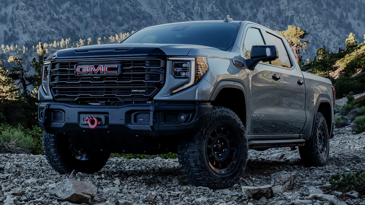 3/4 front and side view of the 2026 GMC AT4 on a rocky mountain trail