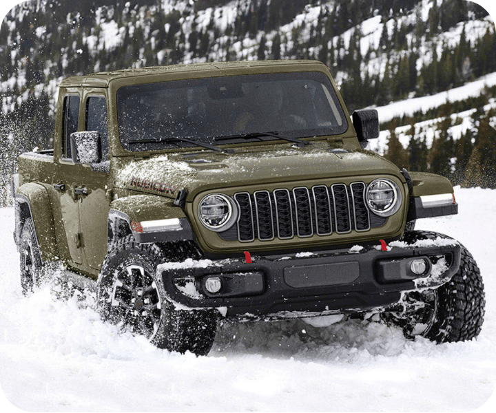 Front and side views of the 2026 Jeep Gladiator in the snow on a mountain, going full throttle