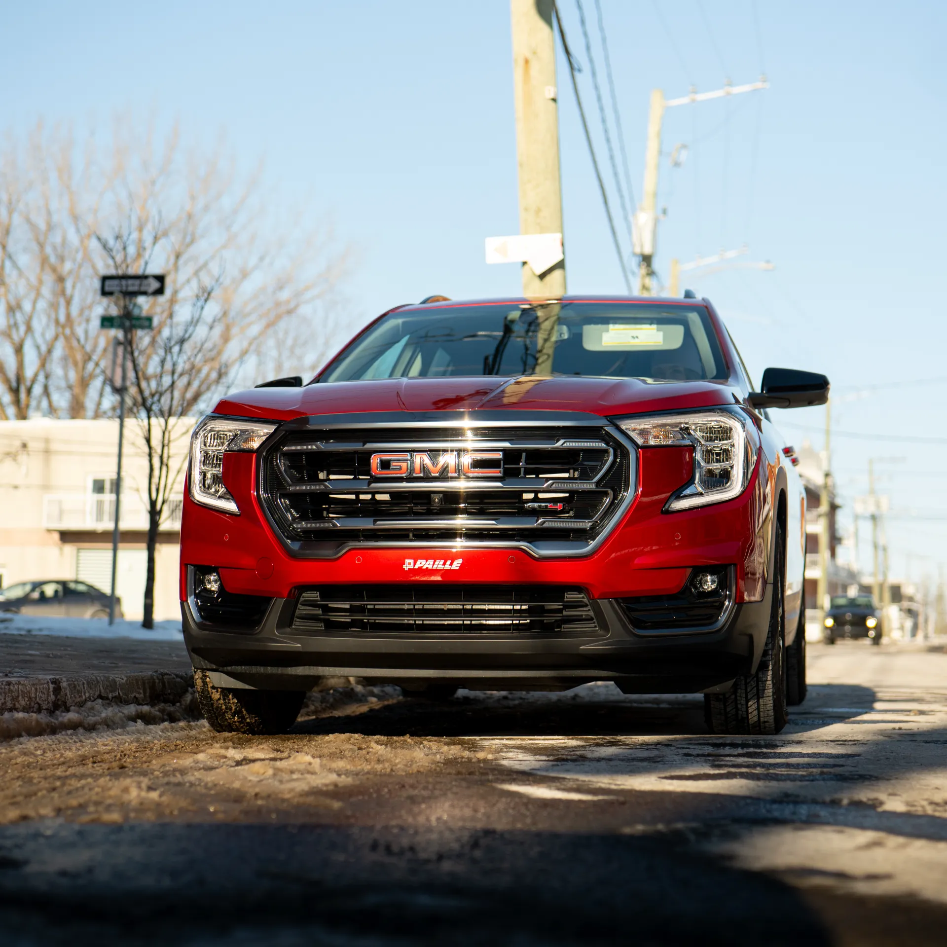 3/4 front view of the red 2026 GMC Terrain parked at a job site
