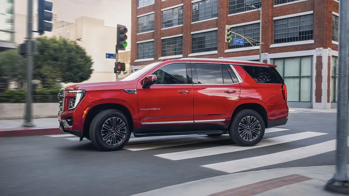3/4 front view of the red 2026 GMC Yukon in the city