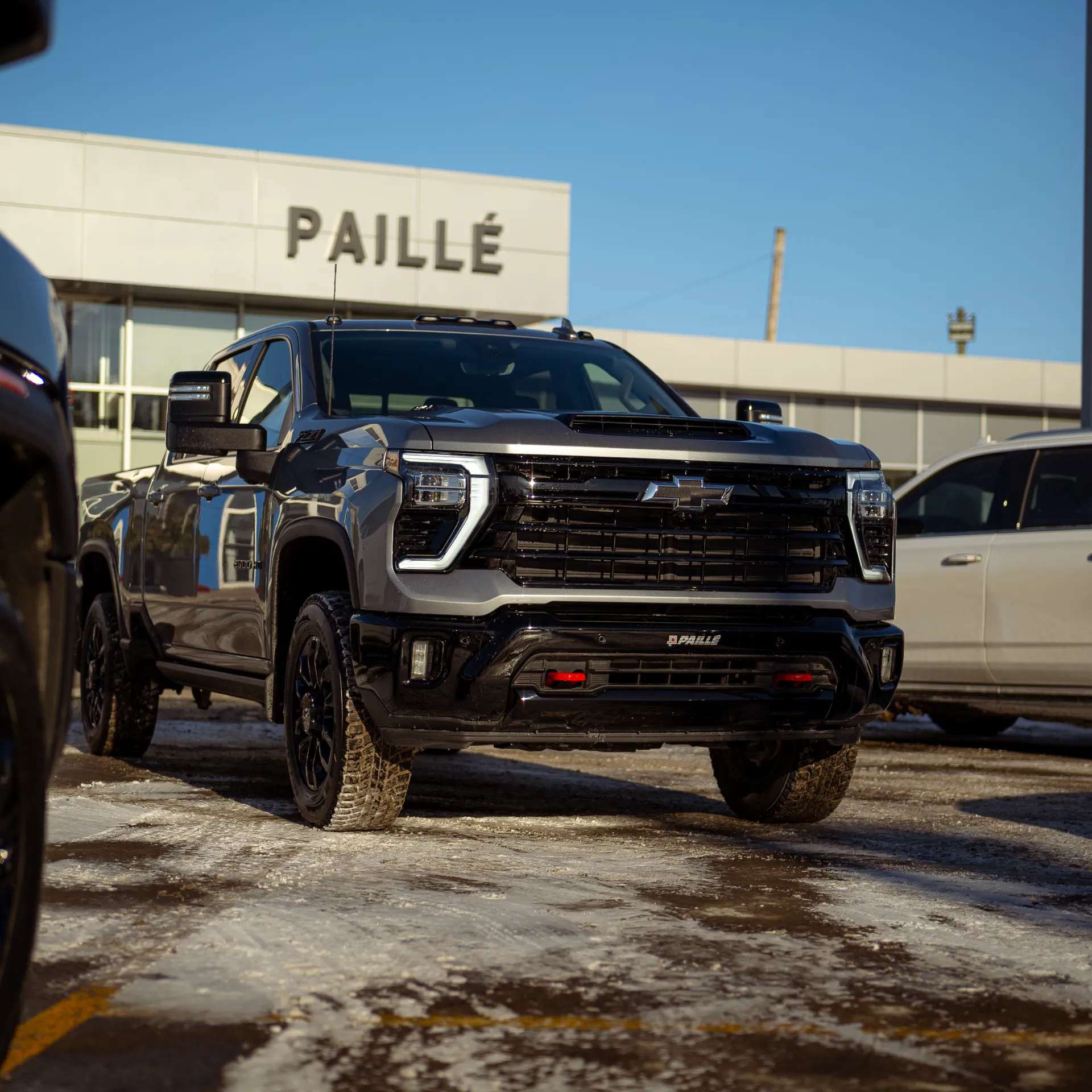 Black GMC truck parked in front of the Paillé dealership.