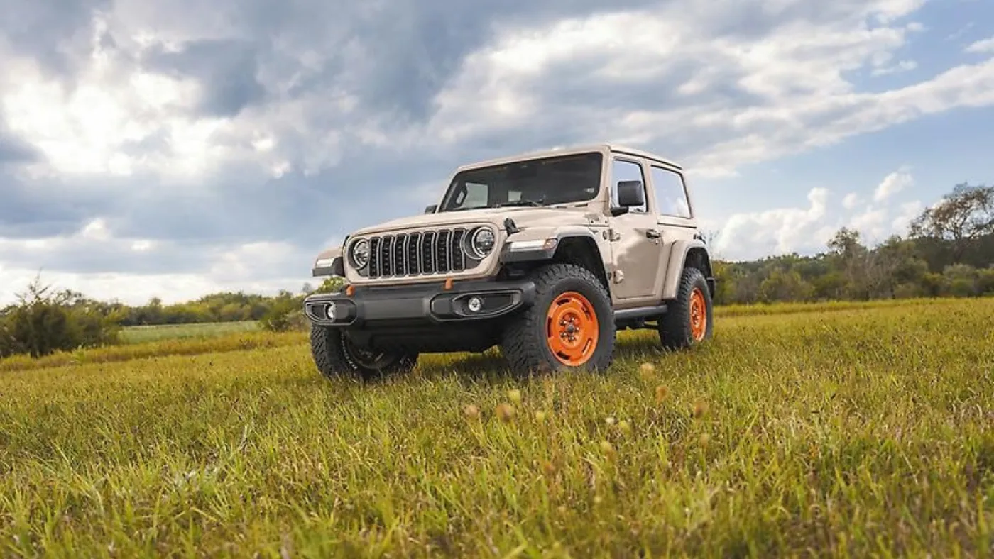 2027 Jeep Wrangler Sarge in military green parked in a field.