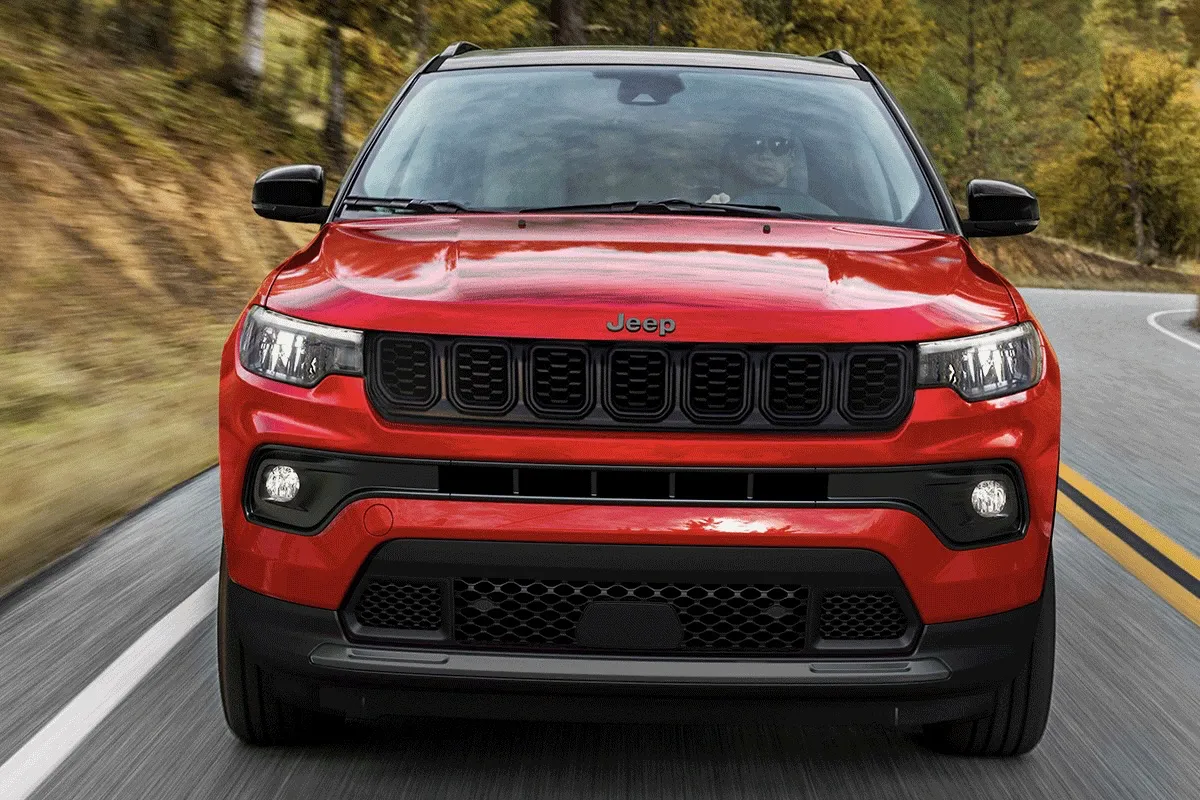 2027 Jeep Compass driving on the road.