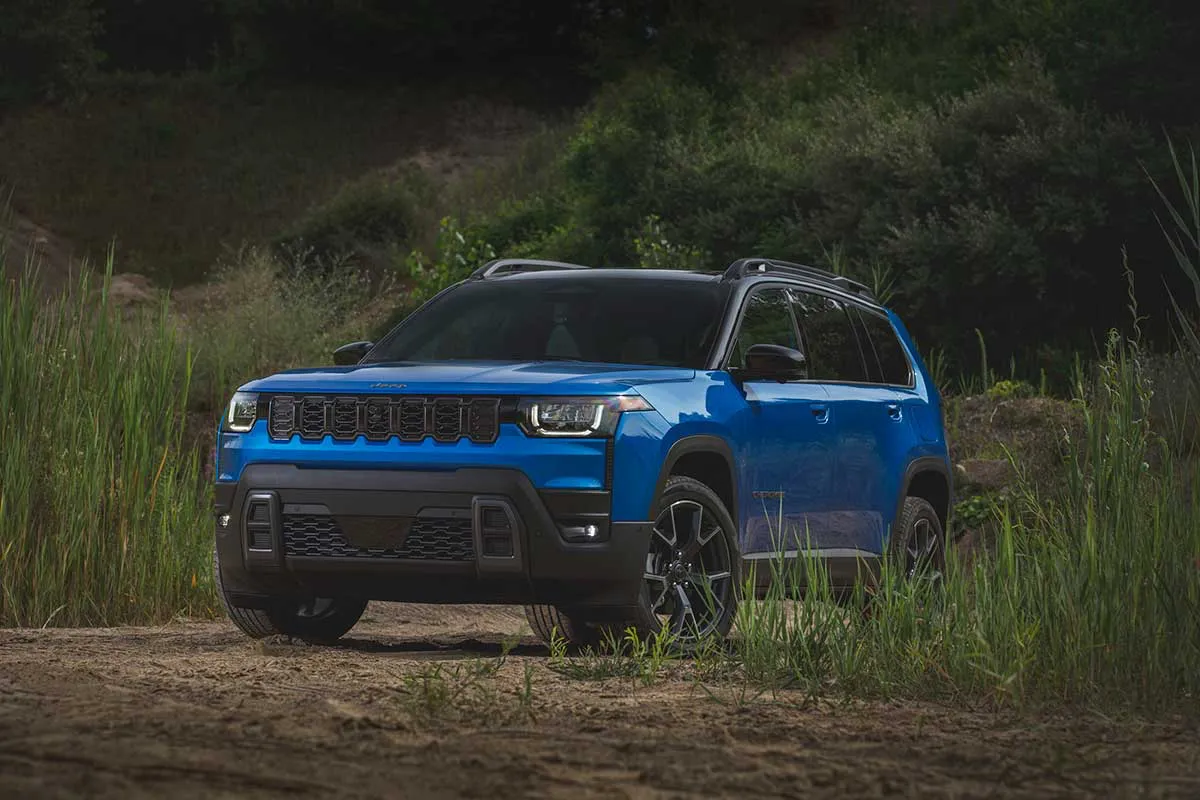 2027 Jeep Cherokee parked on a wooded trail.