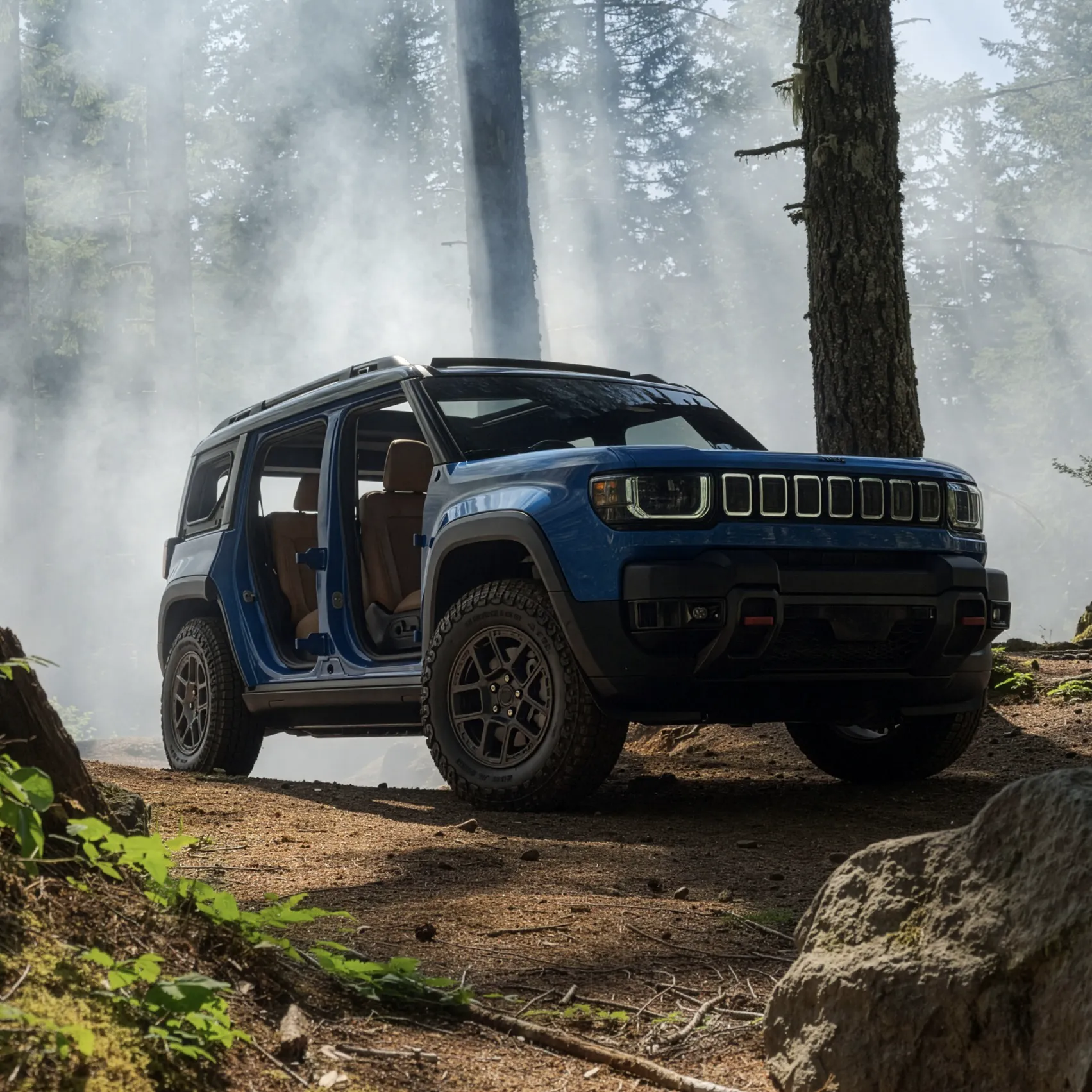 Blue Jeep Recon with its doors open, parked in a misty forest.