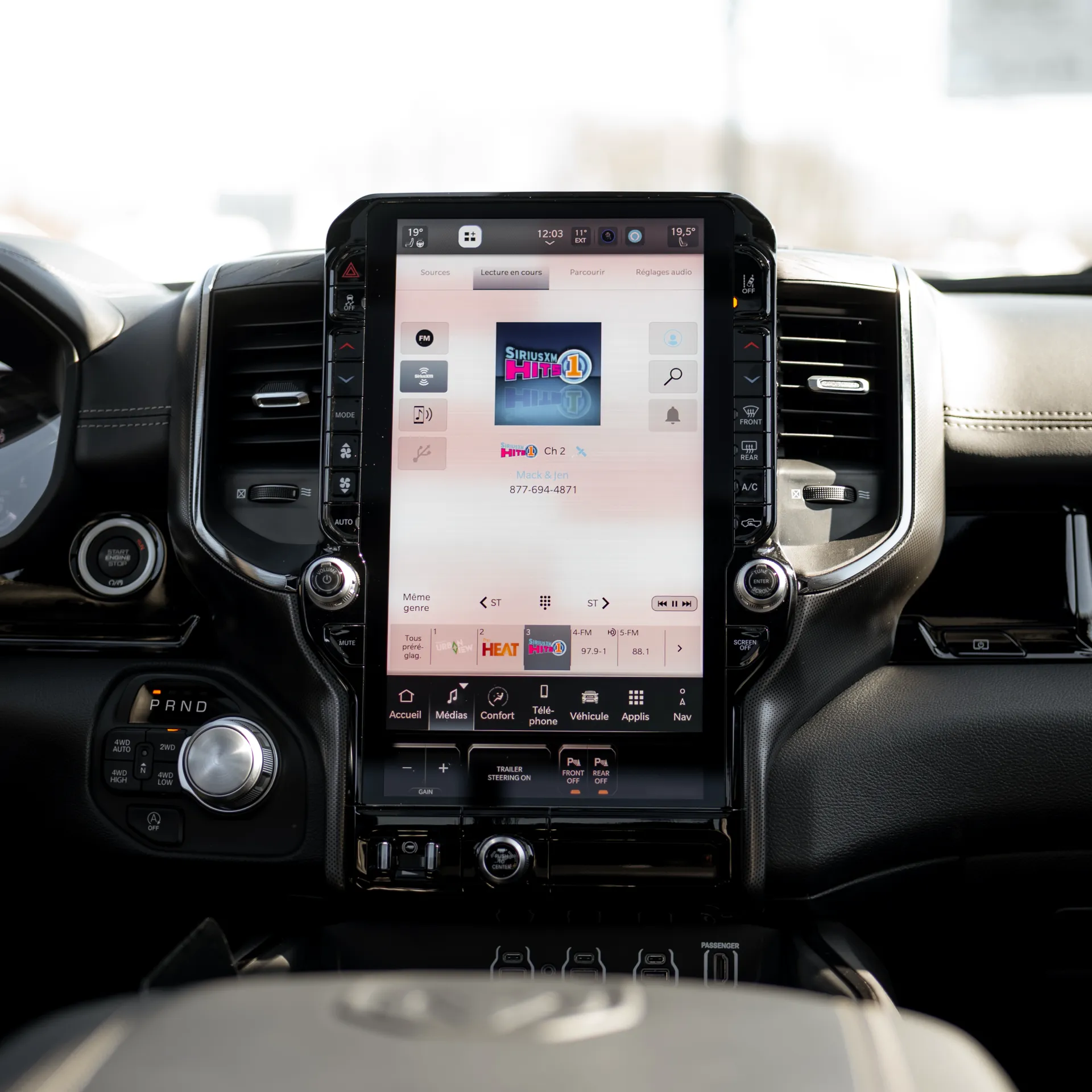 Vertical touchscreen in the centre of a RAM 1500 dashboard, showing the Media menu.